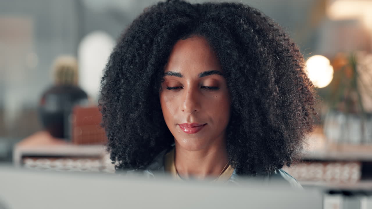 Portrait of a woman with curly hair in an office