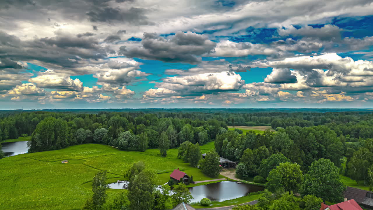 tomada aérea de drones del movimiento de nubes oscuras sobre el campo de trigo a lo largo de lagos en el campo rural en time-lapse