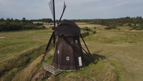 Faddersbol-Molle,-Thisted,-Denmark---An-Observation-of-a-Vintage-Windmill---Aerial-Pullback-Shot