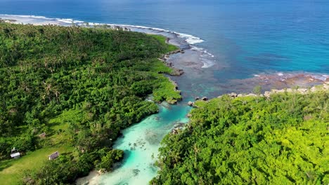 Aerial-drone-scenic-view-of-beautiful-tropical-rocky-coastline-jungle-trees-river-stream-holiday-spot-travel-tourism-beach-South-Pacific-Port-Vila-Vanuatu-4K