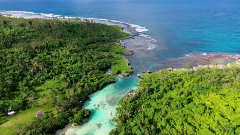 aerial drone scenic view of beautiful tropical rocky coastline jungle trees river stream holiday spot travel tourism beach south pacific port vila vanuatu 4k