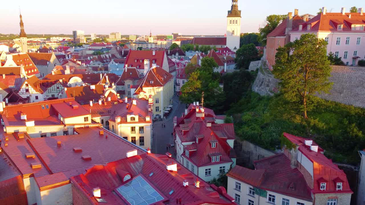 Red rooftops of Tallinn old town on sunny day, aerial drone view