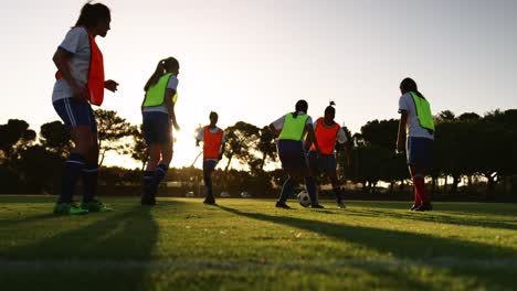 Female-soccer-team-training-on-soccer-field.-4k