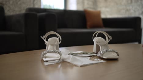 bridal heels and accessories arranged on a table, ready for the wedding ceremony