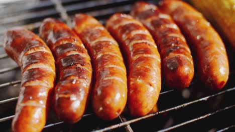 Tasty-juicy-sausages-grilling-over-a-fire