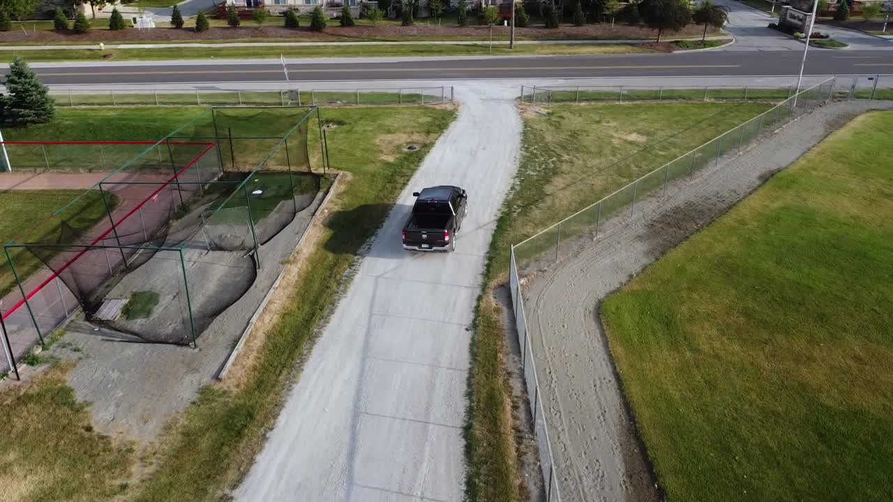 Tracking a gravel path while a truck passes.