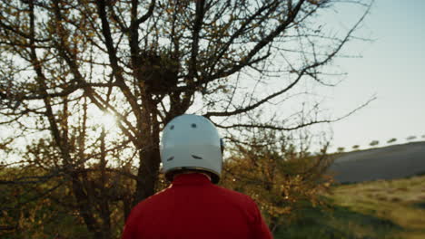 astronaut walks among trees foliage and flora in new planet