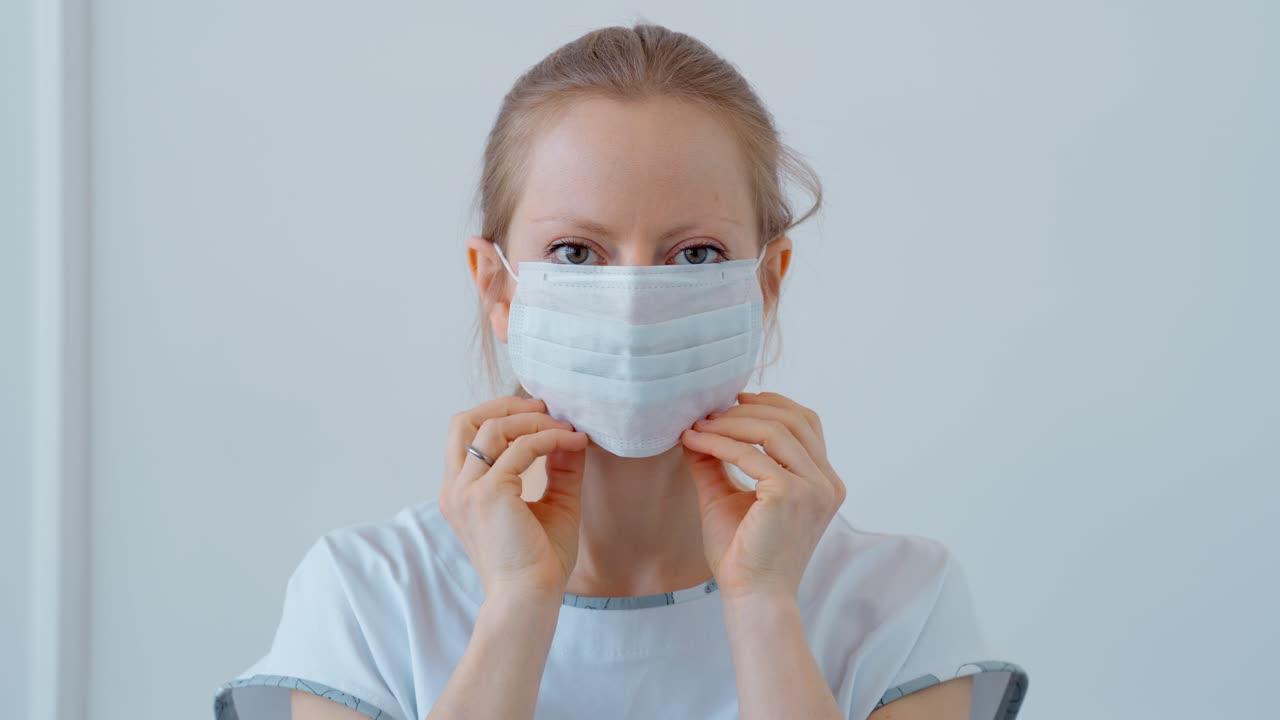 Woman Putting on a Face Mask