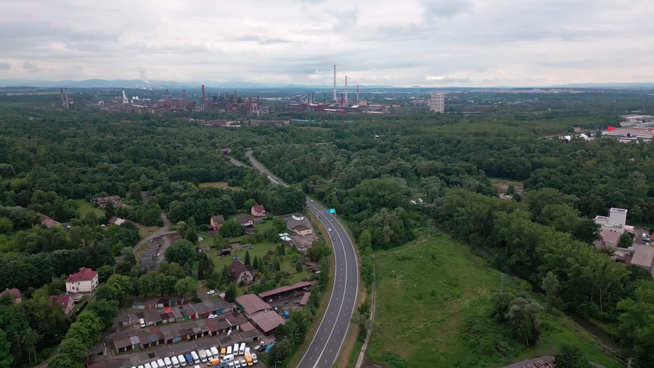 Major road traffic highway leading to distant Industrial zone AERIAL VIEW
