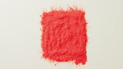 Video-of-red-coloured-powder-with-copy-space-on-white-background