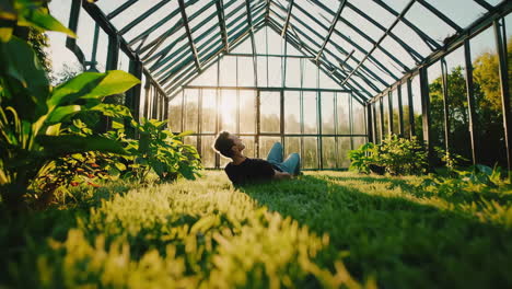 man relaxing in a sunny greenhouse