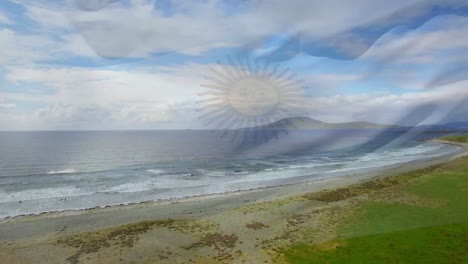 composición digital de la bandera argentina ondeando contra la vista aérea de la playa