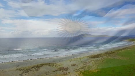 digital composition of waving argentina flag against aerial view of the beach