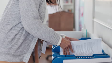 Paperwork,-hands-and-teacher-in-classroom