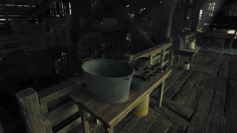 rustic interior of an old barn with wooden furniture and tools