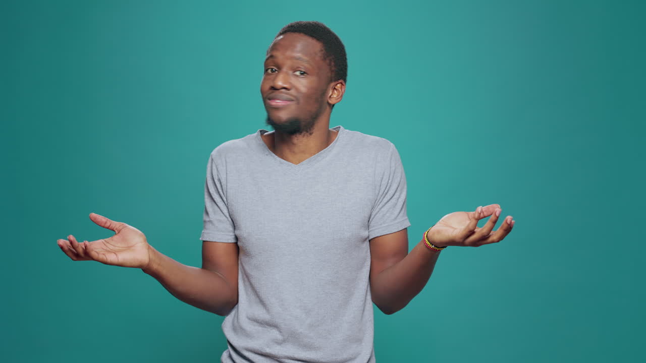 Unsure clueless model doing i dont know gesture on camera