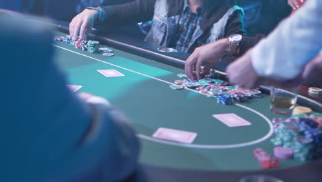 female casino dealer distributing poker cards to group of players