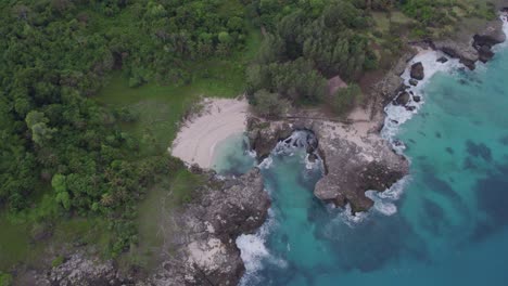 pantai mandorak white sand beach with clear blue water top down, aerial