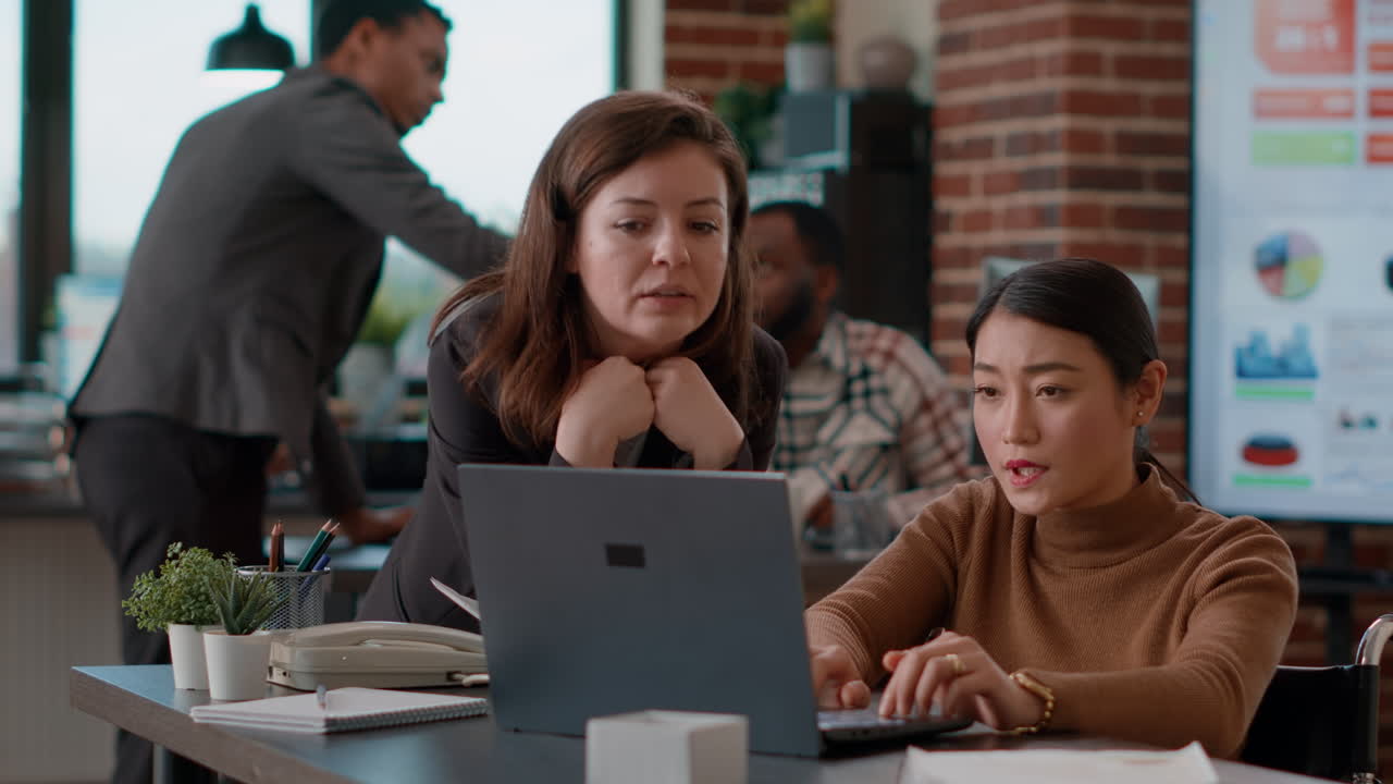 Business women doing teamwork to analyze statistics graphs