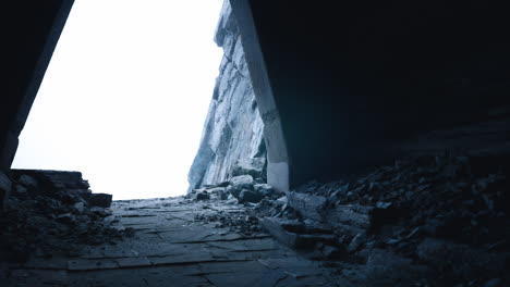 light breaks through an abandoned cave revealing rocky terrain