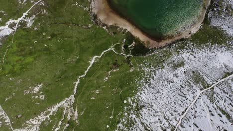 flight over two green mountain lakes near the three peaks in the dolomites in italy, sunny weather