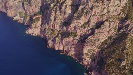 tilt up shot of rocky coastline at mallorca, balearic islands, spain