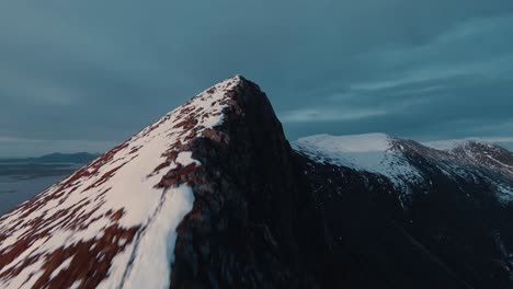 Reaching-snow-covered-mountain-peek-with-fpv-drone-view