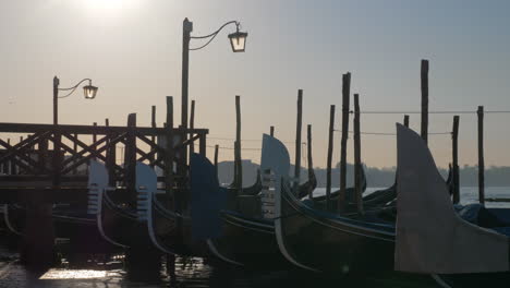 scene of venice dock with gondolas moored near the pier