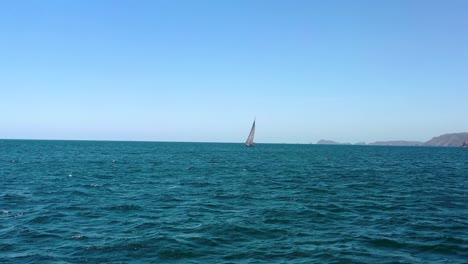 sailboat sailing into a pacific bay in mexico