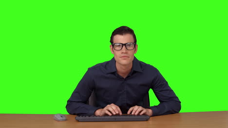 Businessman-typing-at-his-desk