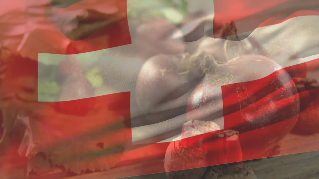 Swiss flag with fresh vegetables including tomatoes and mushrooms in kitchen setting