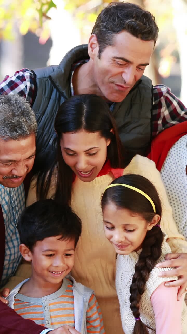 Multi-generation family taking a selfie in the park