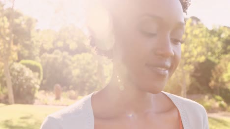 Portrait-of-attractive-woman-is-smiling-in-a-park