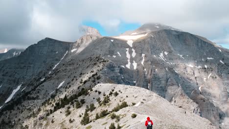 lone hiker crossing the alpine plateau in mount olympus in greece - wide shot