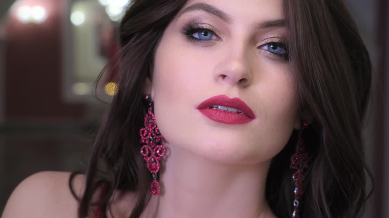 Beautiful Woman with Red Lips and Earrings