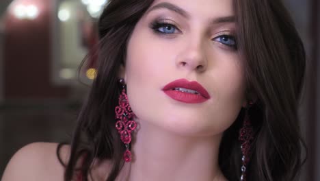 beautiful woman with red lips and earrings
