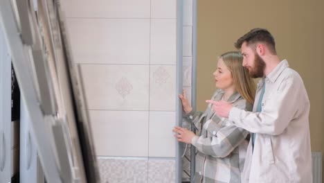 couple choosing tiles in a showroom
