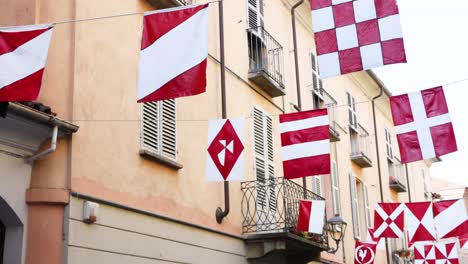 various flags hanging on a building facade