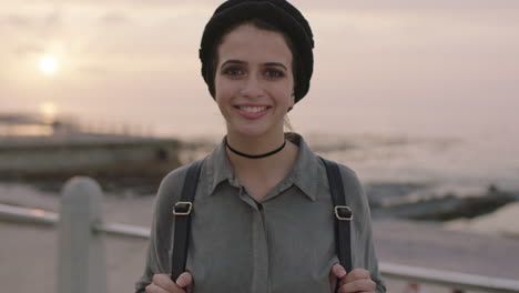 portrait of beautiful young girl in seaside beachfront smiling cheerful posing looking to camera