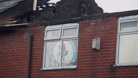 fire damaged home in blackburn, uk with roof collapsed