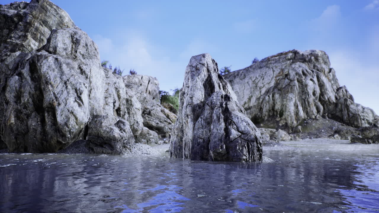Rock formation by the serene coastline reflecting the clear blue sky
