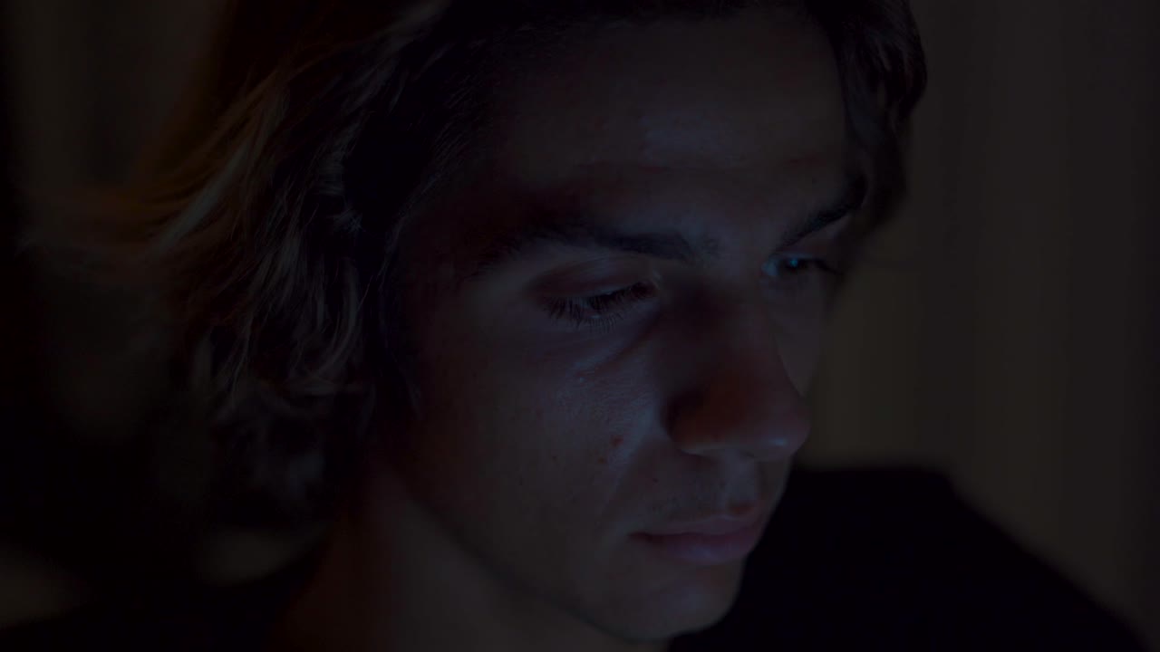 Eye close up of someone working on a computer by night