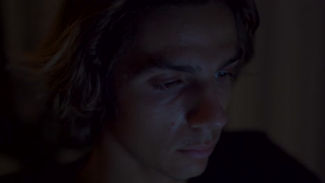 Eye close up of someone working on a computer by night