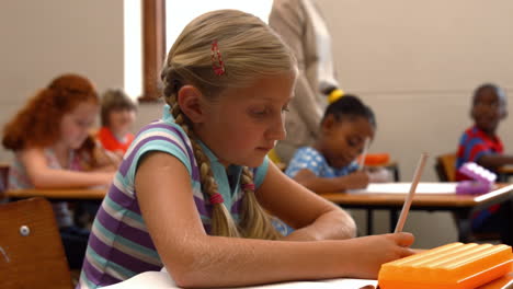 Schoolgirl-smiling-at-camera-in-class