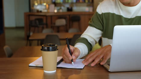 male executive writing on diary in office cafeteria 4k