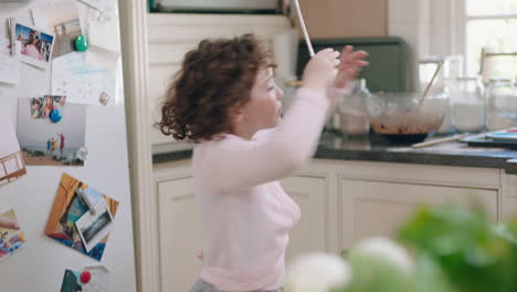 happy-little-girl-dancing-in-kitchen-having-fun-waving-maginc-wand-playing-pretend-doing-funny-dance-moves-enjoying-weekend-at-home