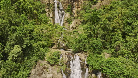 Ella-Sri-Lanka-Aerial-v40-drone-epic-flyover-upward-capturing-spectacular-Ravana-Falls-with-water-cascading-down-a-rocky-cliff-surrounded-by-lush-dense-forests---Shot-with-Mavic-3-Cine---April-2023