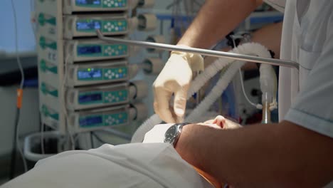 anesthesist performs an intubation of the patient before the operation