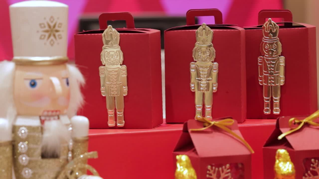 Nutcracker Christmas decorations on candy boxes, gold and red theme