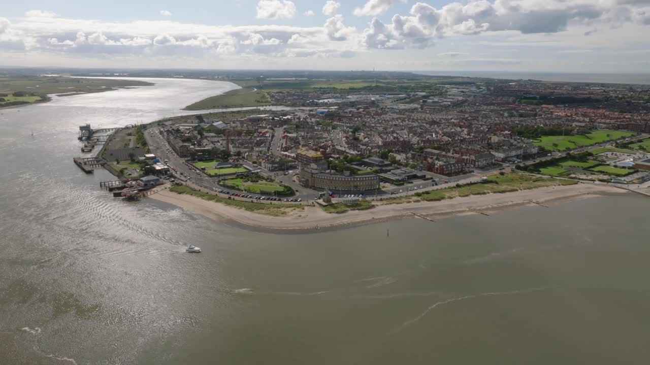 Peninsula Seaside Town Of Fleetwood With Small Boat Exiting River Wyre Estuary And Light Reflecting From Water. Lancashire, UK